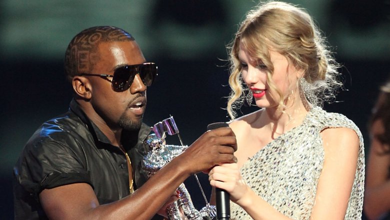 Kanye West grabbing a microphone from Taylor Swift