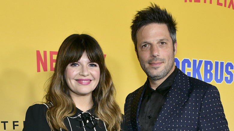 Casey Wilson and David Caspe posing at an event