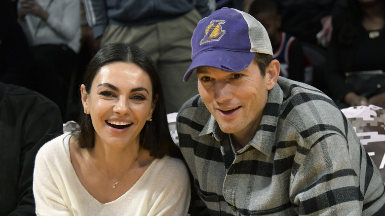 Mila Kunis and Ashton Kutcher at a basketball game