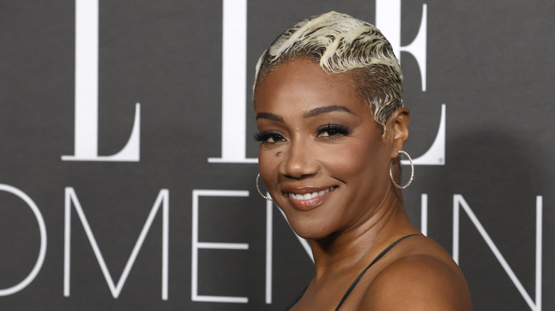 Tiffany Haddish smiling on a red carpet