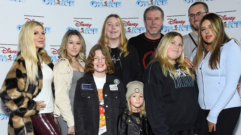 Tori Spelling and her family posing at an event