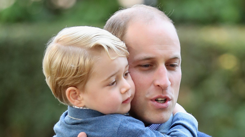 Prince William holding Prince George