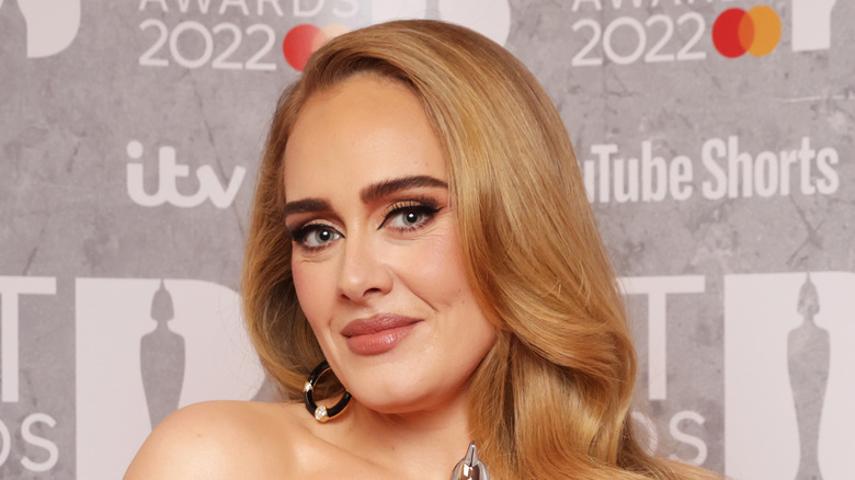 Adele at an event, smiling
