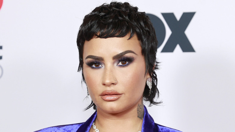 Demi Lovato at an event, looking serious