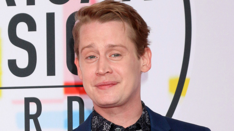 Macaulay Culkin at an event, smiling