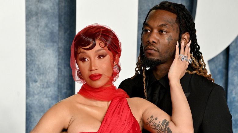 Cardi B with hand on Offset's face
