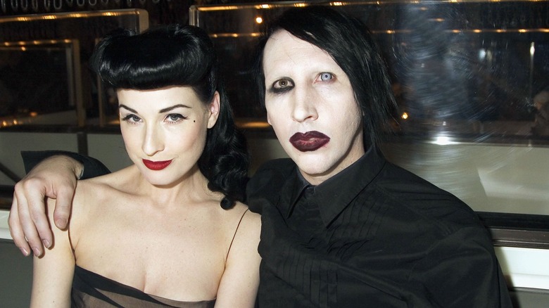 Marilyn Manson with arm around Dita Von Teese