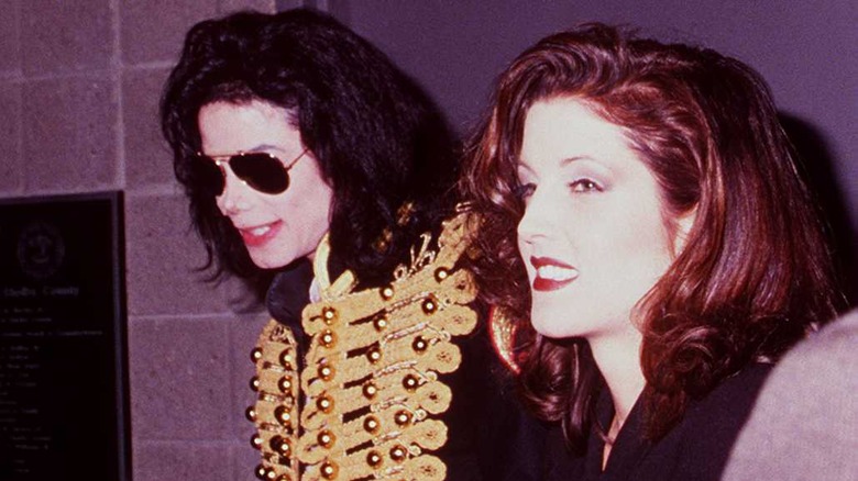 Michael Jackson wearing sunglasses, Lisa Marie Presley smiling