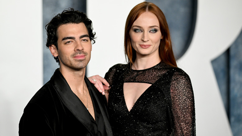 Sophie Turner with hand on Joe Jonas' shoulder