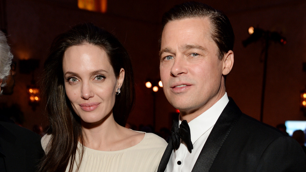 Angelina Jolie and Brad Pitt looking at camera