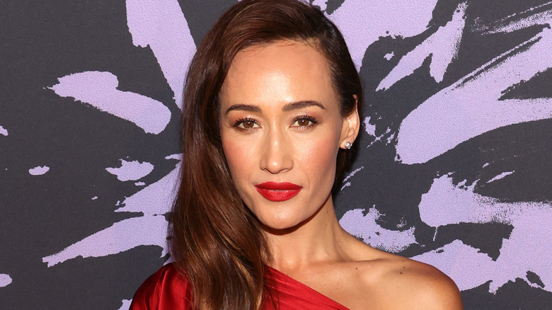 Maggie Q posing at an event