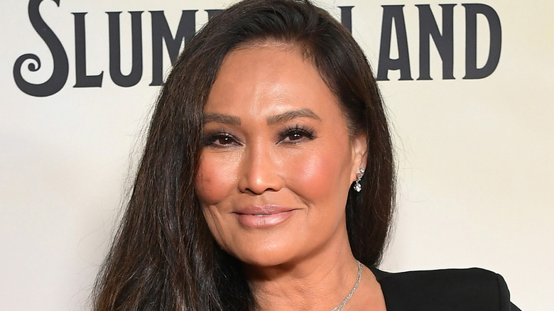 Tia Carrere posing at movie premiere