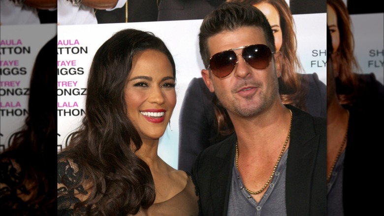 Paula Patton smiling besides Robin Thicke