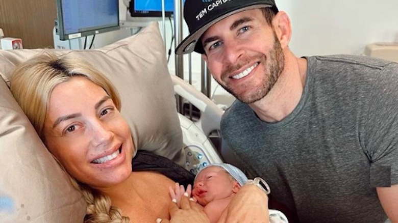 Heather Rae and Tarek El Moussa holding newborn