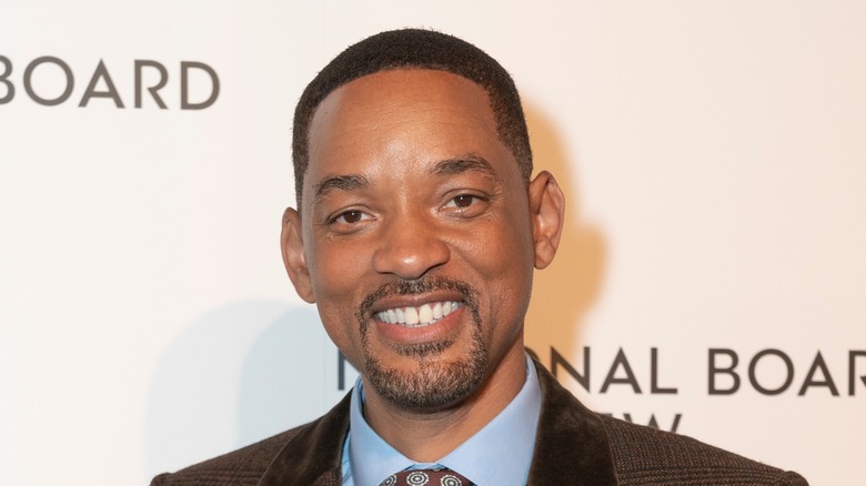 Will Smith smiles in checked suit