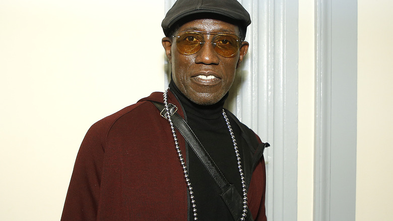 Wesley Snipes smiling, hat sunglasses