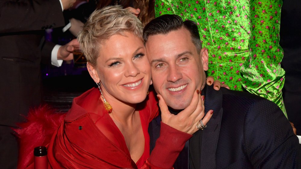 Pink holding Carey Hart's chin, both smiling