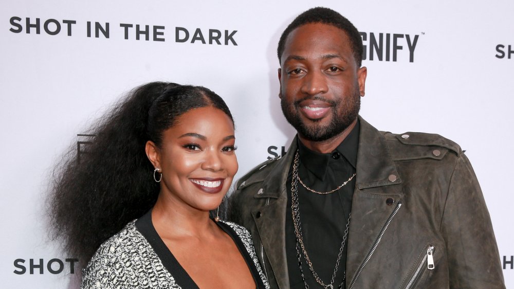 Gabrielle Union and Dwyane Wade standing on red carpet