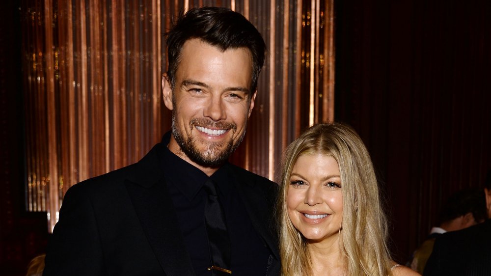 Josh Duhamel standing next to Fergie, both grinning