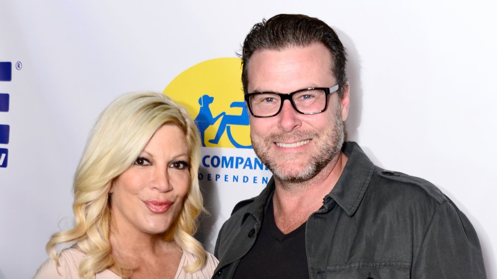 Tori Spelling and Dean McDermott, both posing and smiling