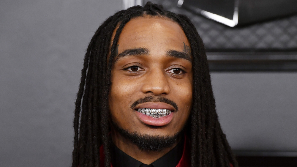 Quavo showing with his diamond grillz