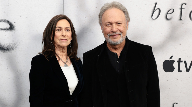 Janice and Billy Crystal wearing black jackets while on the red carpet