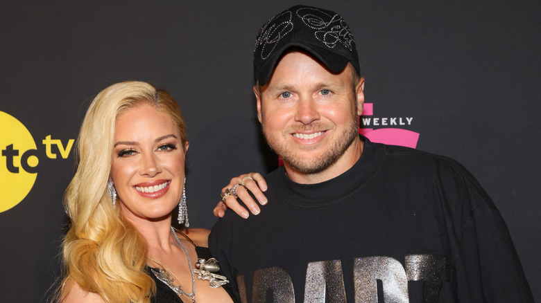 Heidi Montag Pratt wearing a black embellished dress and Spencer Pratt wearing a black t-shirt and black bedazzled hat