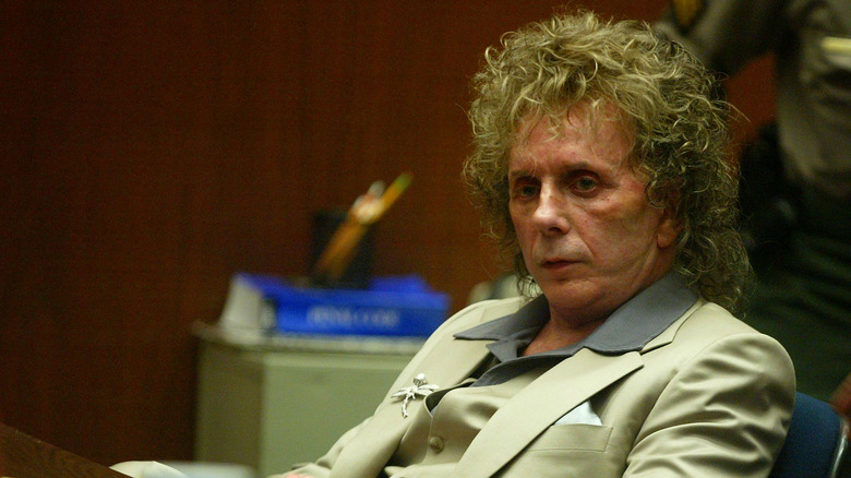 Phil Spector seated, looking down