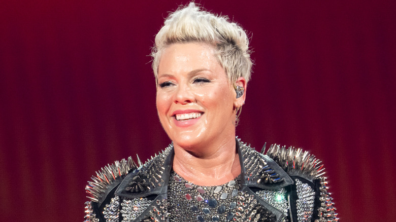 Pink smiling on stage during a performance in 2024