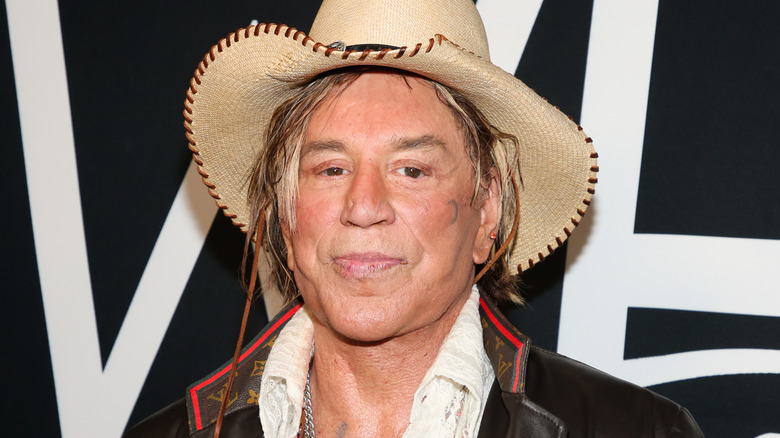 Mickey Rourke posing in hat