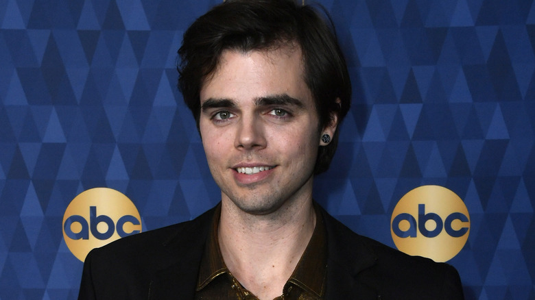 Reid Ewing smiling and posing