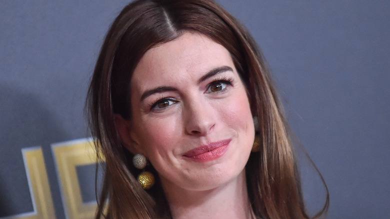 Anne Hathaway wearing a middle part, smiling