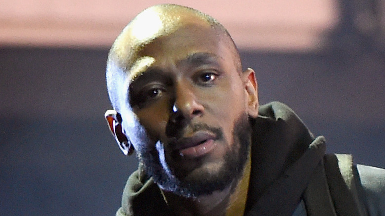 Yasiin Bey wearing a hoodie