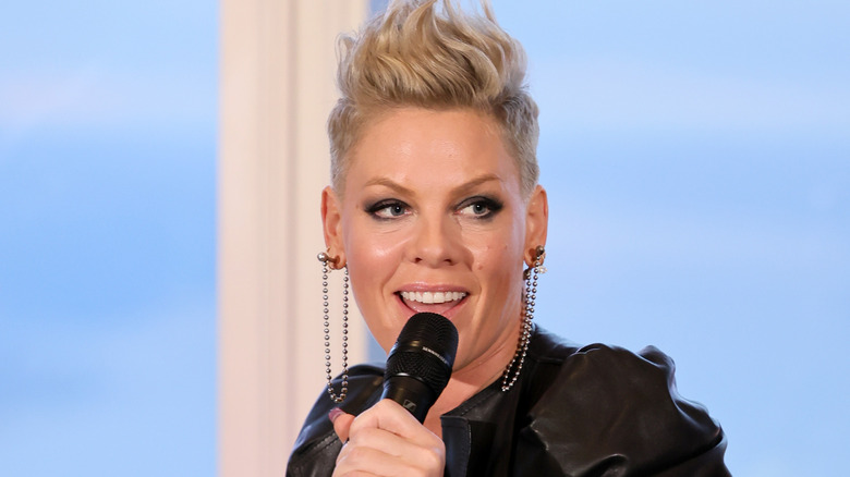 Pink speaking into a microphone.