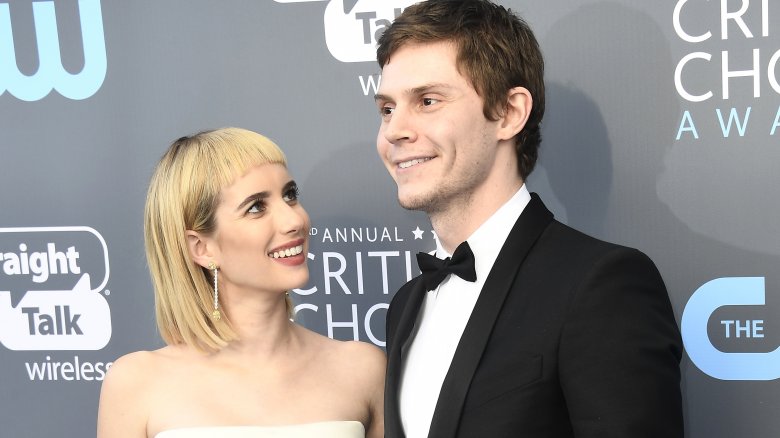 Emma Roberts smiling at Evan Peters, also smiling