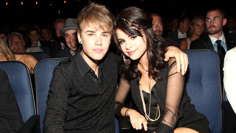 Justin Bieber with his arm around smiling Selena Gomez