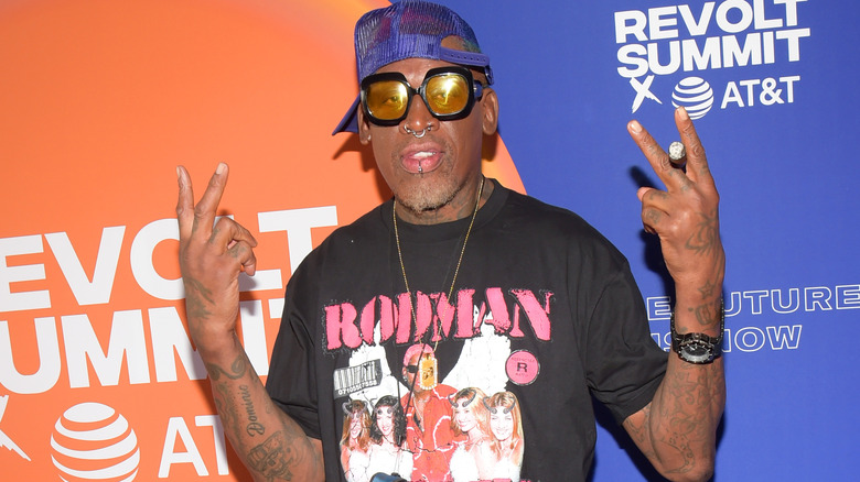 Dennis Rodman shows two peace signs