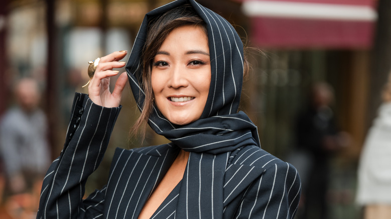 Ashley Park wearing a pinstripe hood