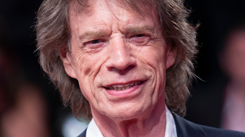 Mick Jagger smiling in suit