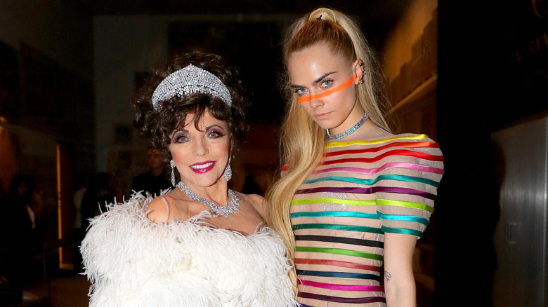 Joan Collins and Cara Delevingne posing