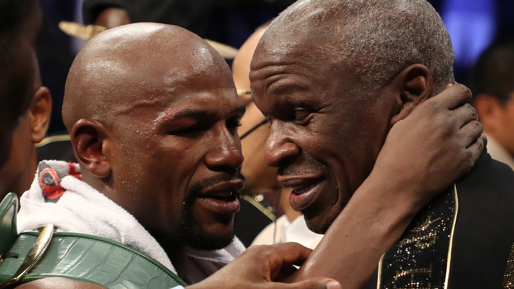 Floyd Mayweather Jr. wraps his arm around Floyd Mayweather Sr. for a hug