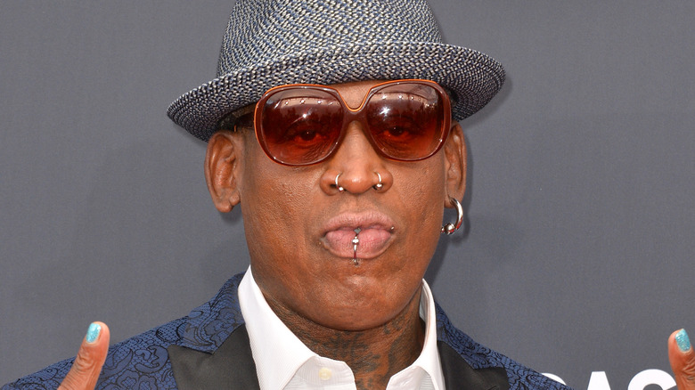 Dennis Rodman posing hat shades