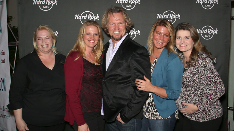 Kody Brown posing and smiling with his wives