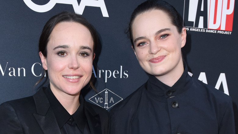 Elliot Page and Emma Portner smiling together