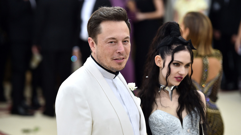 Elon Musk poses with Grimes