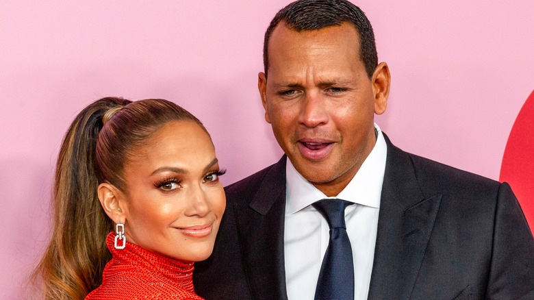 JLo smiling with ARod making a face