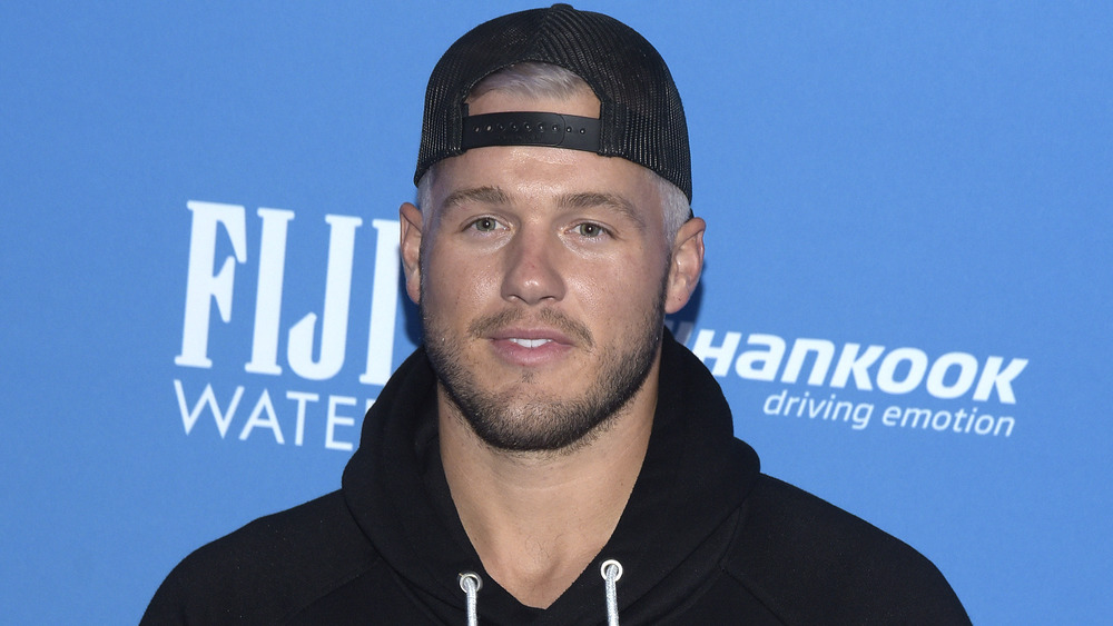 Colton Underwood wearing a backwards ballcap 