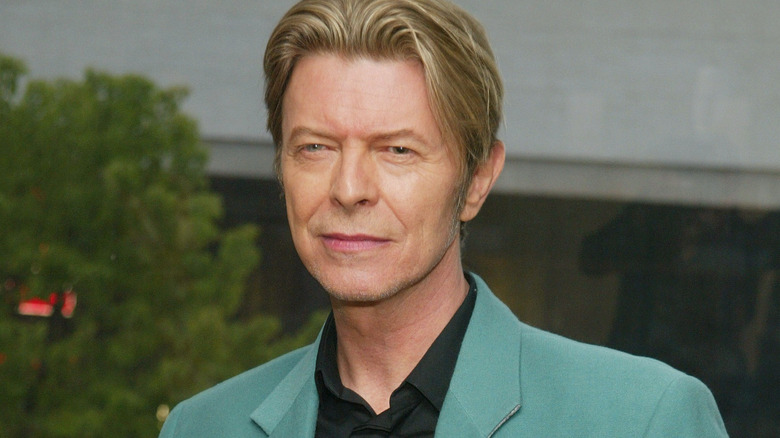 David Bowie smiling in blue suit