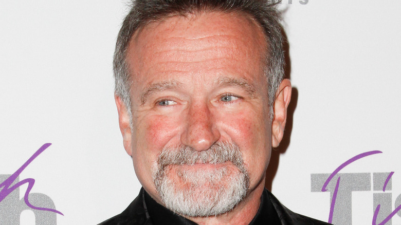 Robin Williams with facial hair, grinning