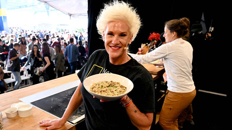 Anne Burrell holding bowl of pasta